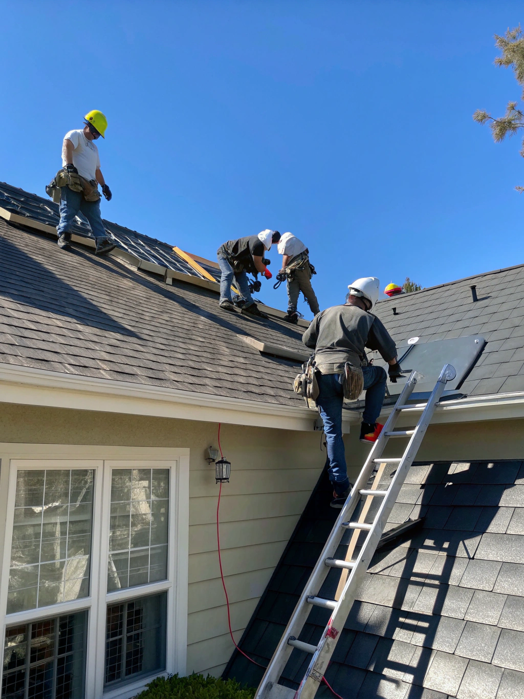 Roofing crew installing new shingles on a residential home in Maryland
