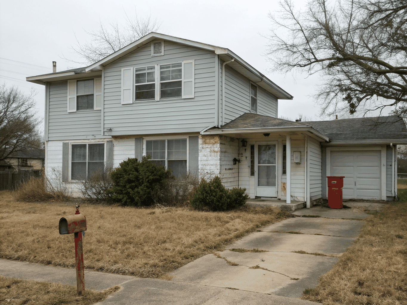 Suburban home with outdated vinyl siding before exterior remodel